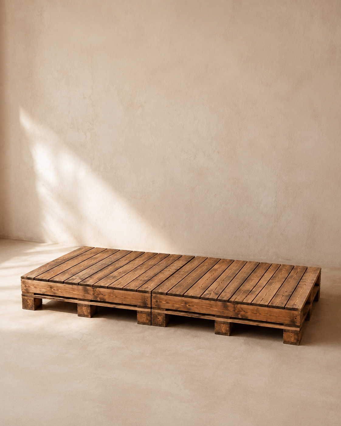 Long low wooden picnic table made from two adjoining pallets